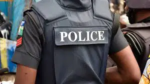 Police officers at an uncompleted building in Eket, Akwa Ibom, where an AK-47 rifle was found.