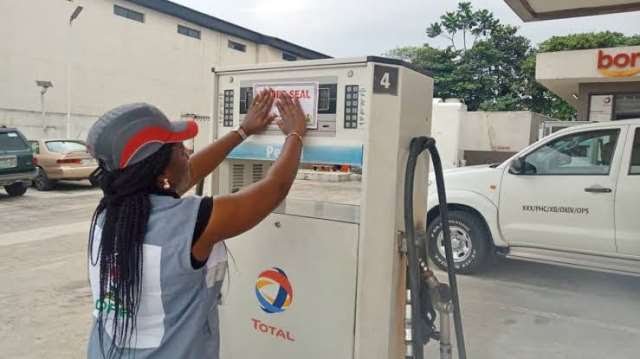 NMDPRA officials inspecting a fuel station pump in Ogun State during a crackdown on under-dispensing petrol practices.