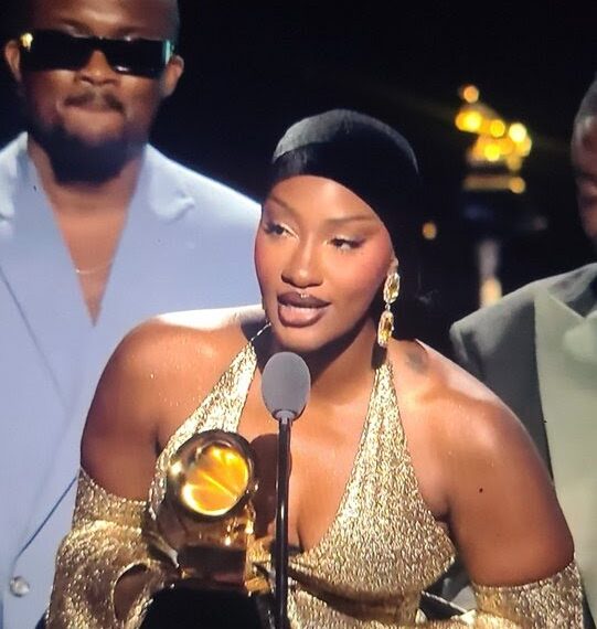 Tems holding her Grammy Award for Best African Music Performance, celebrating her second win