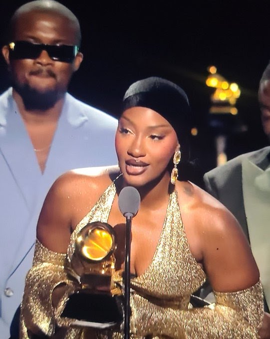 Tems holding her Grammy Award for Best African Music Performance, celebrating her second win