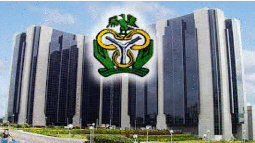 CBN Governor Olayemi Cardoso announcing interest rate cut at press briefing in Abuja with Nigerian flag and central bank logo visible
