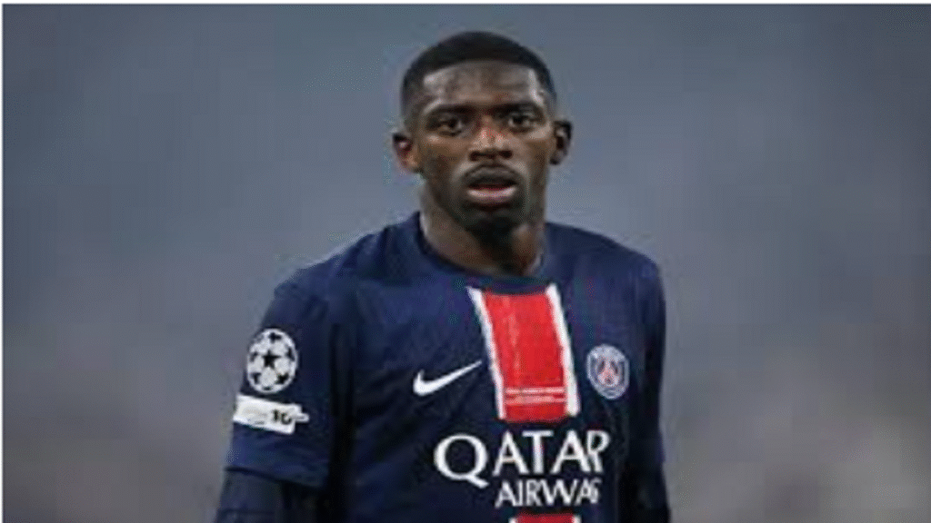 Ousmane Dembele smiling while holding the golden Ballon d'Or trophy at the 2025 awards ceremony podium in Paris