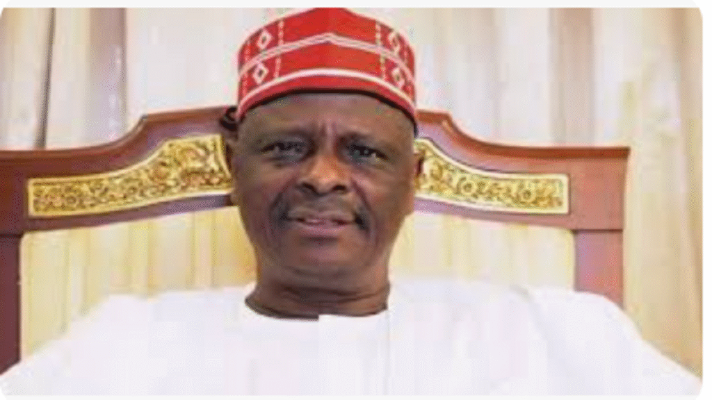Rabiu Kwankwaso addressing supporters at a political rally, wearing the distinctive red cap of the Kwankwasiyya movement