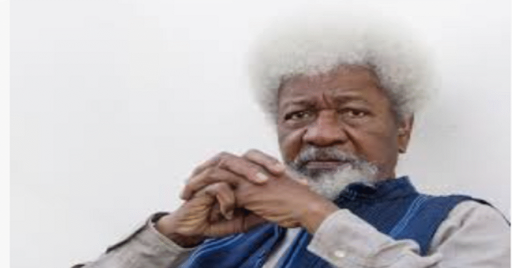 Professor Wole Soyinka speaking at podium during literary event, wearing traditional Nigerian attire